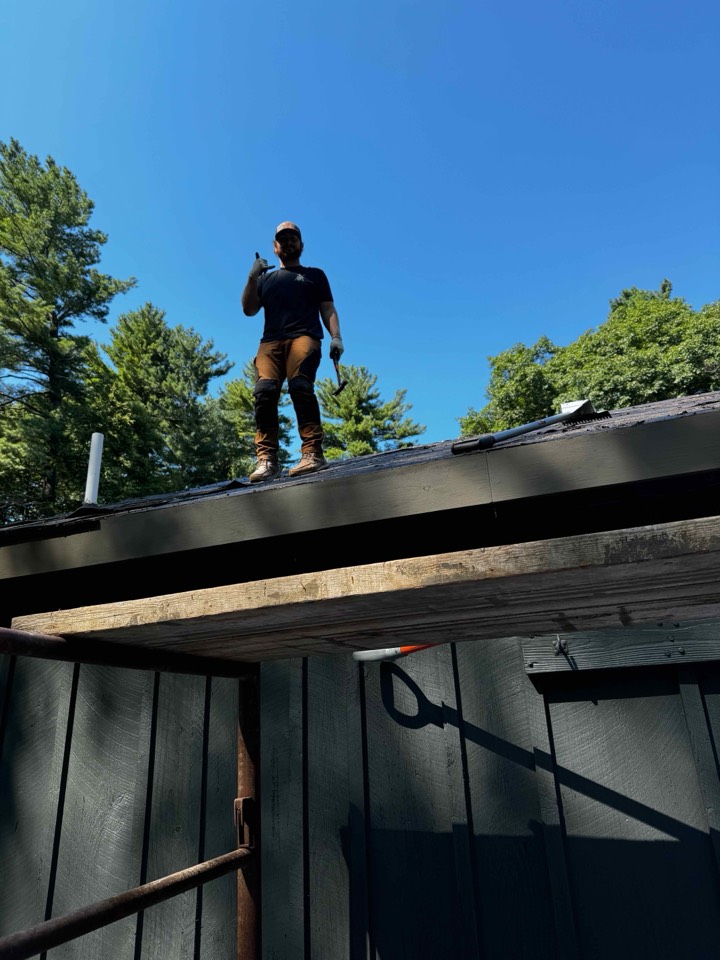 Foxpoint roofer silhouetted against a clear sky