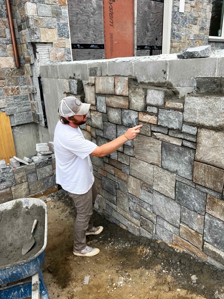 Foxpoint mason tooling joints on a granite veneer wall